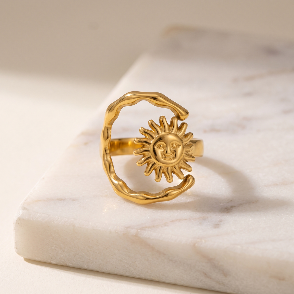 Sun and Moon adjustable open ring in gold, lying on white marble