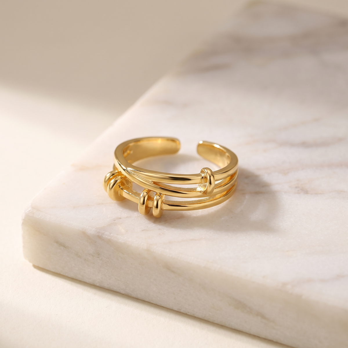 Thin adjustable open stacking ring, lying on white marble
