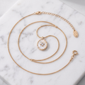 Mother-of-pearl shell pendant necklace in gold on white marble