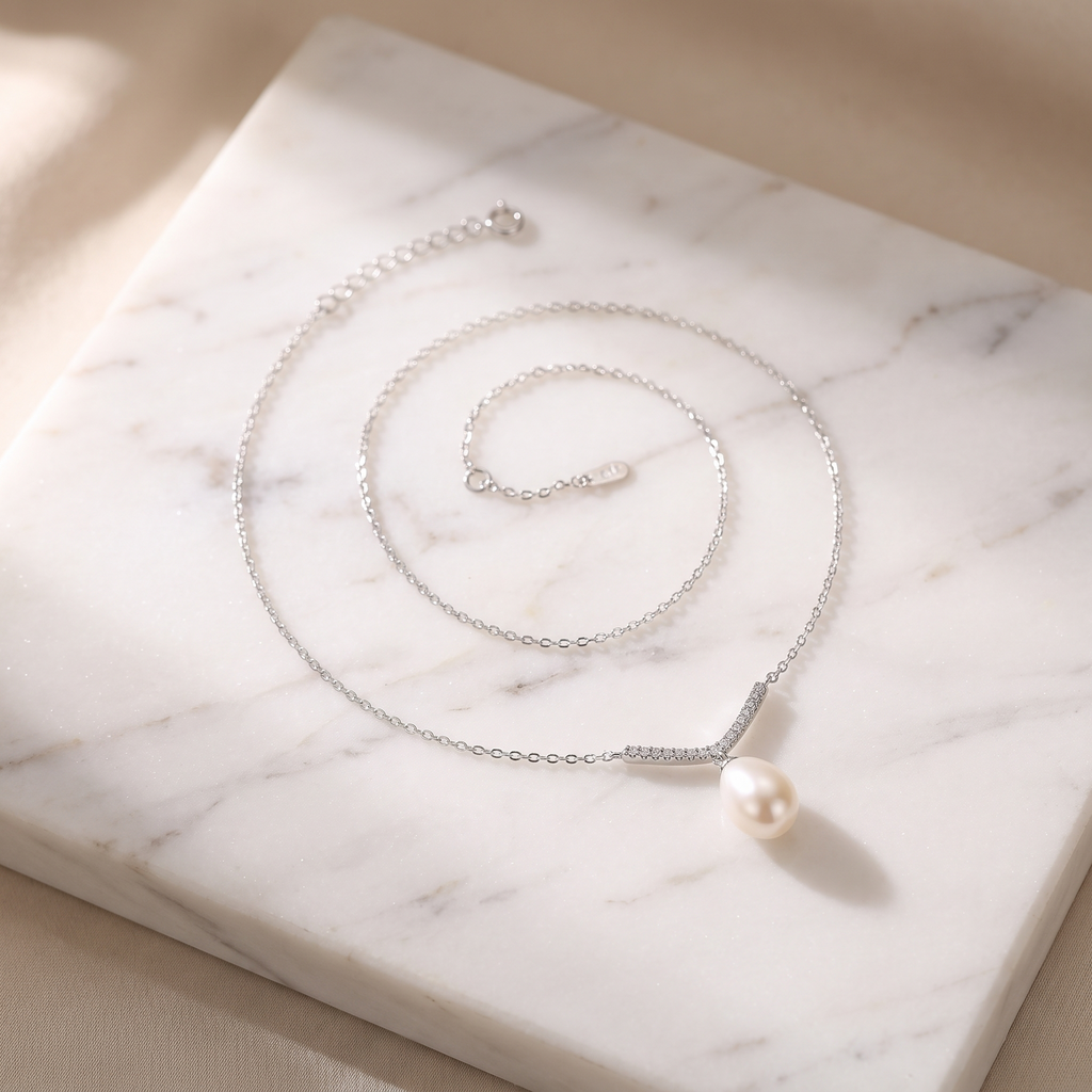 Freshwater pearl and sterling silver necklace on white marble