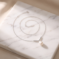 Freshwater pearl and sterling silver necklace on white marble