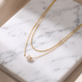 Double strand pearl necklace on white marble