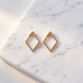 Double hoop zircon earrings on white marble