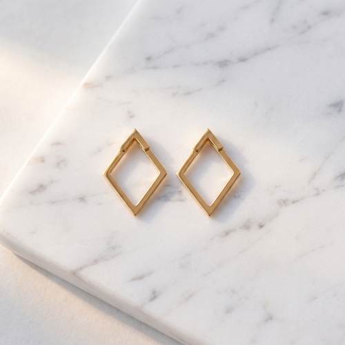 Double hoop zircon earrings on white marble