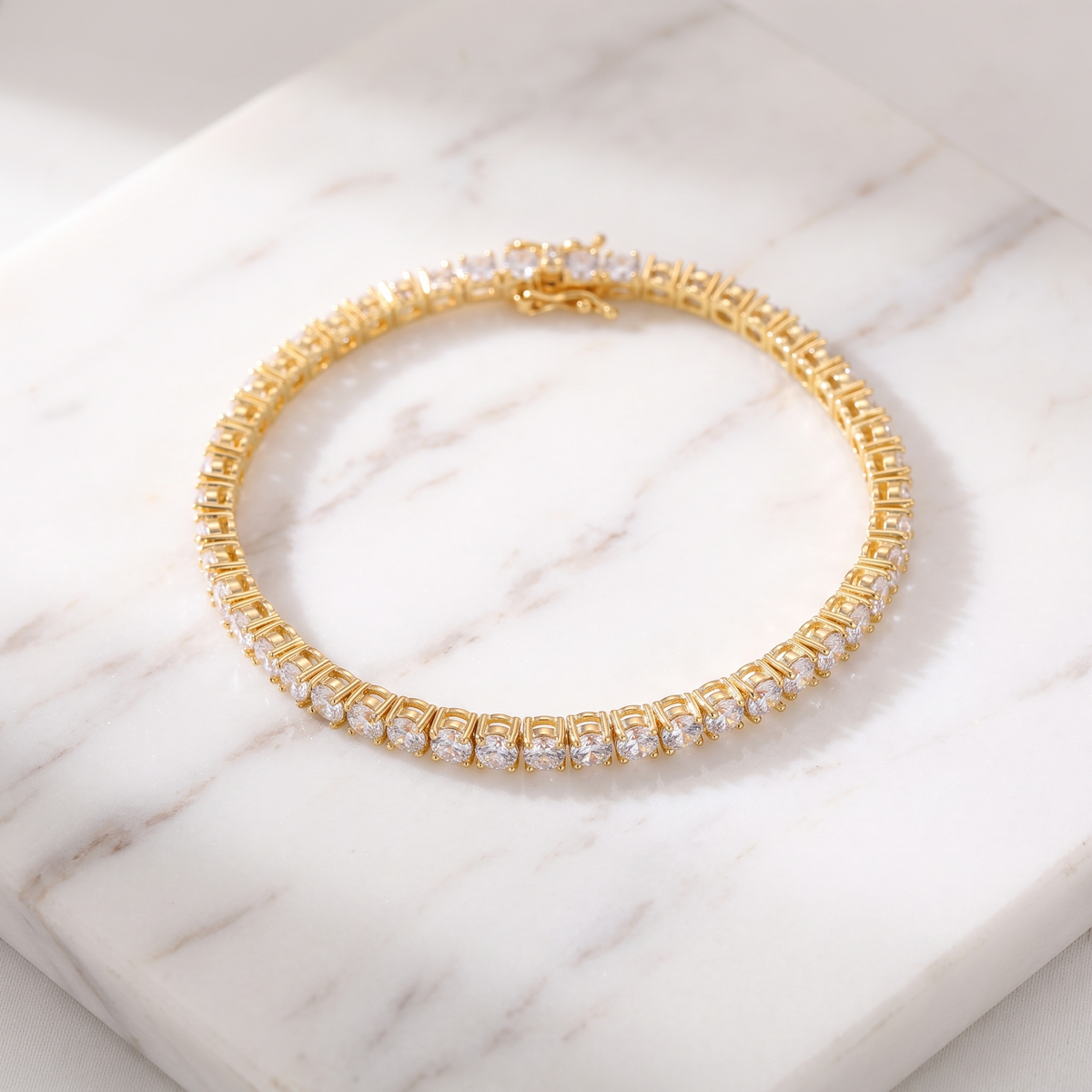 Gold zircon tennis bracelet on white marble